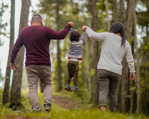 man and woman carrying toddler