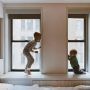 two kids playing beside glass windows