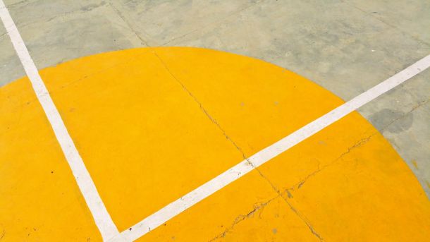 gray concrete pavement with yellow and white paint
