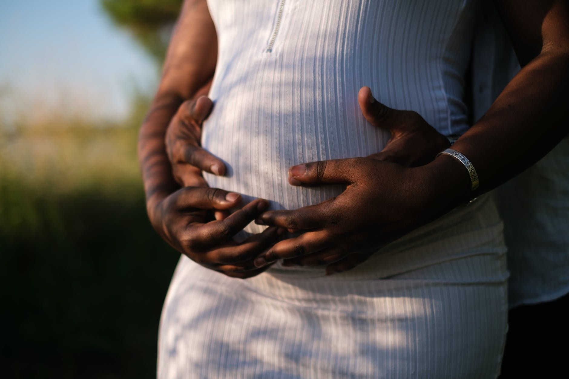 hands of a couple embracing the baby inside her growing belly hands of a couple embracing the baby inside her growing belly hands of a couple embracing the baby inside her growing belly hands of a couple embracing the baby inside her growing belly