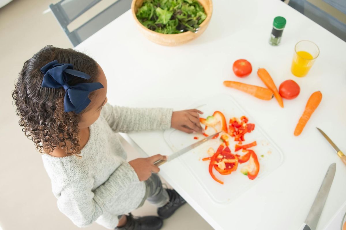 girl slicing bell peppers