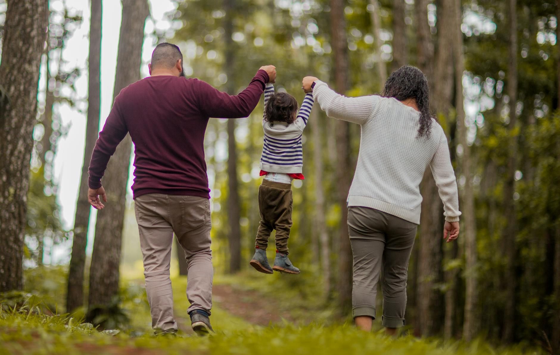 man and woman carrying toddler man and woman carrying toddler man and woman carrying toddler man and woman carrying toddler