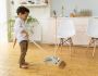 little kid sweeping floor
