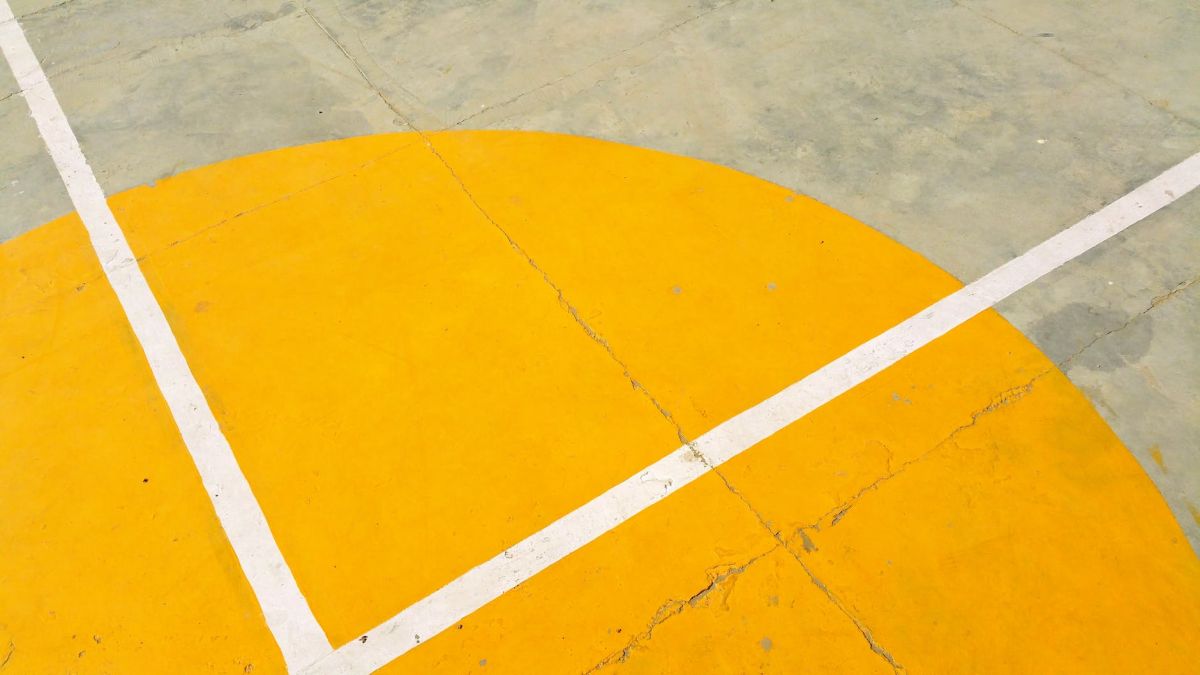 gray concrete pavement with yellow and white paint